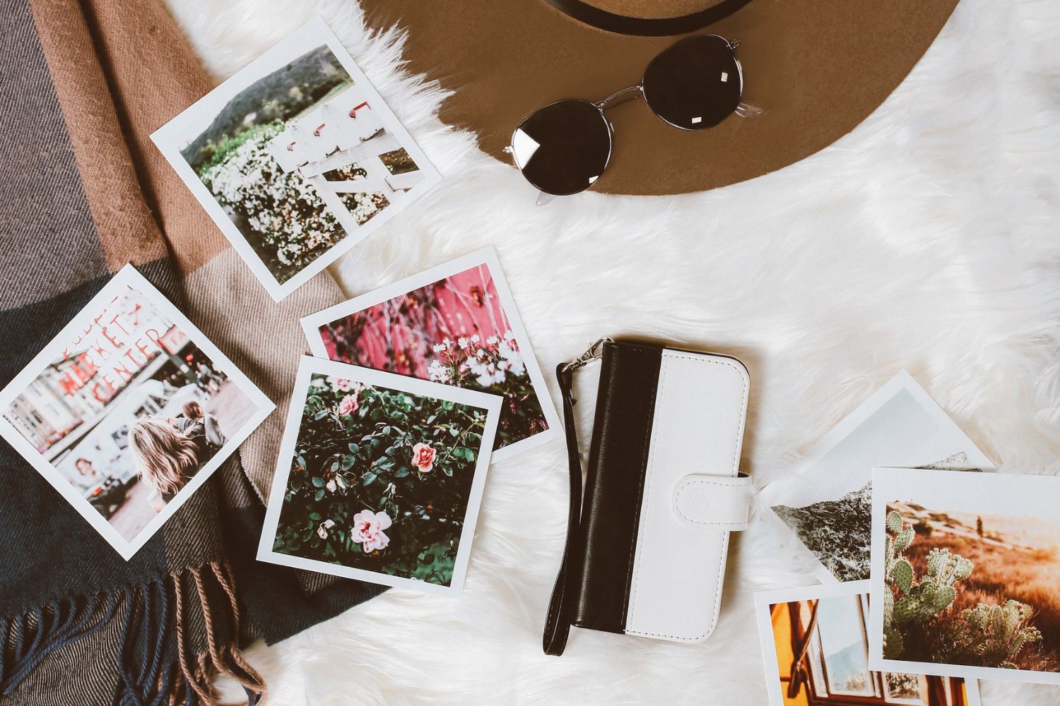 scattered printed photo on white blanket Photo by Clarisse Meyer on Unsplash