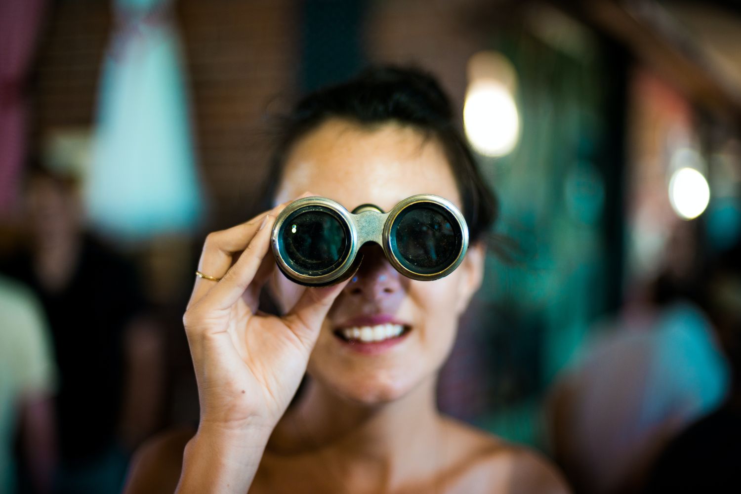 woman takes photos with binoculars camera Photo by Chase Clark on unsplash