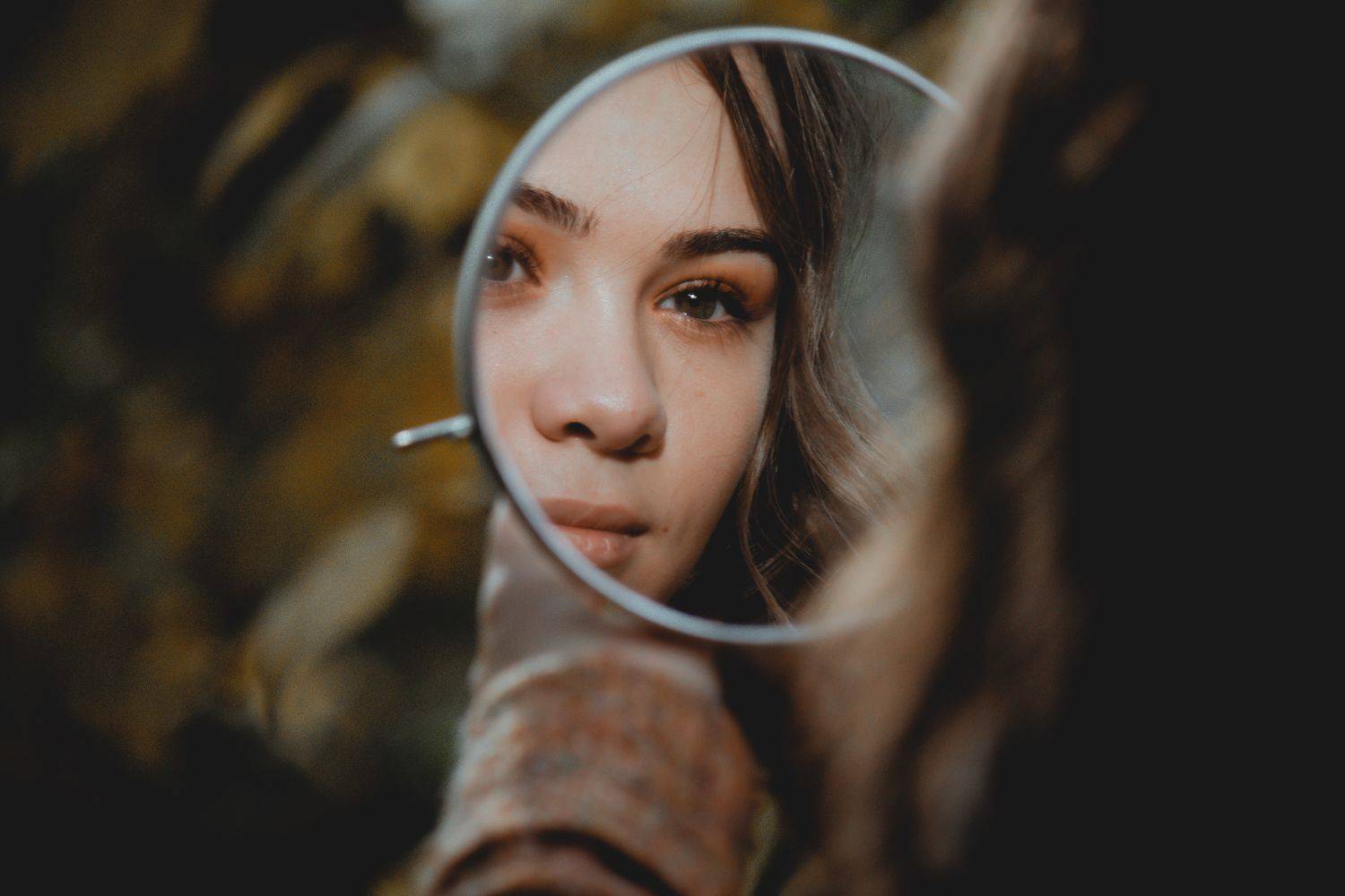 woman's face in the mirror Photo by Elisa Photography on unsplash