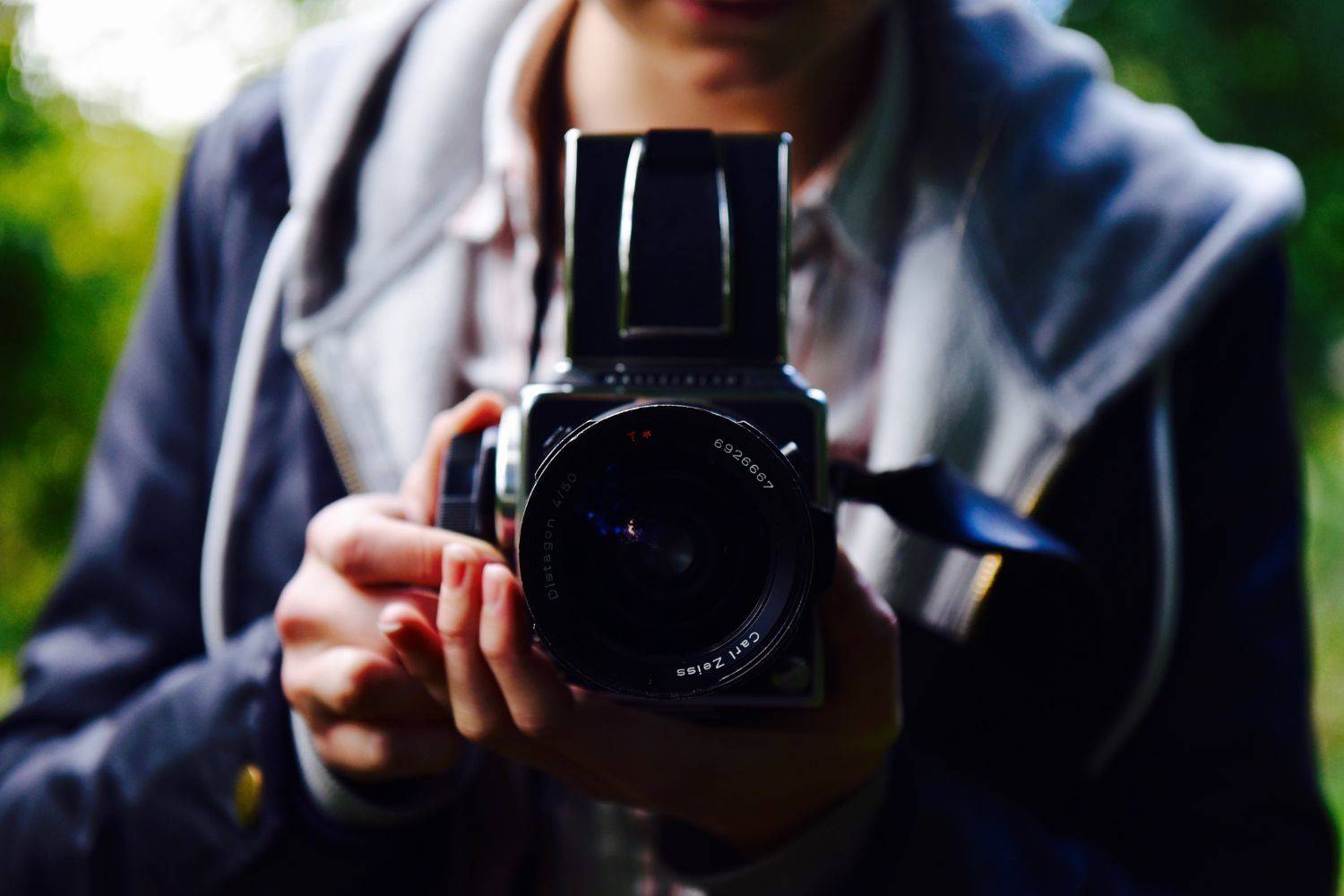 man takes hasselblad camera in hands Photo by Joe Ridley Beth Martin on unsplash