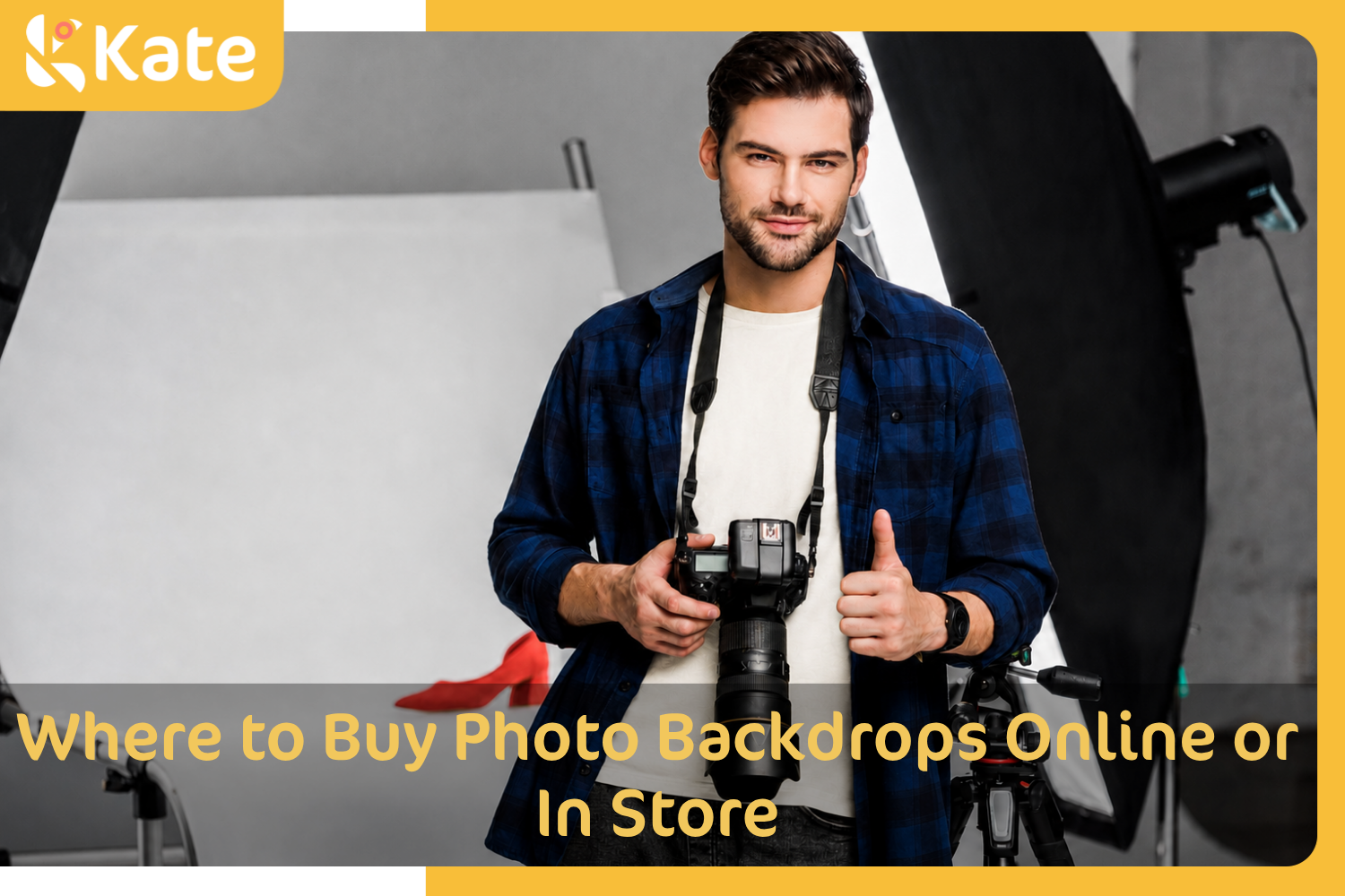 Photographer holding a camera in a studio with photo backdrop