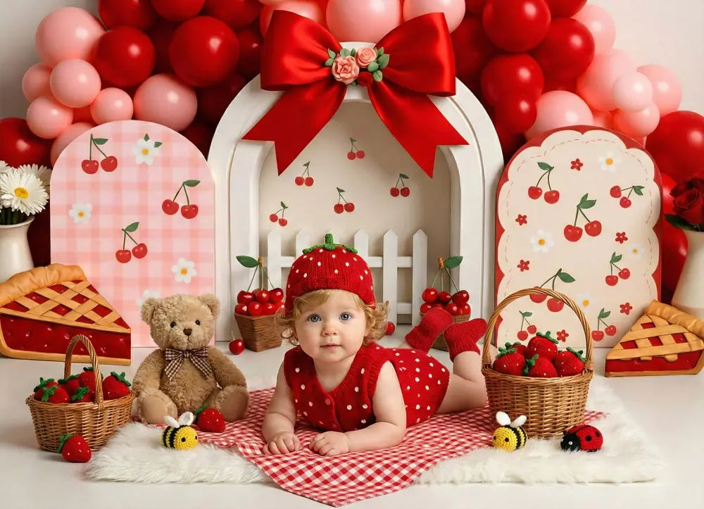 Baby girl in a cherry-themed cake smash photo shoot with balloons and decorations
