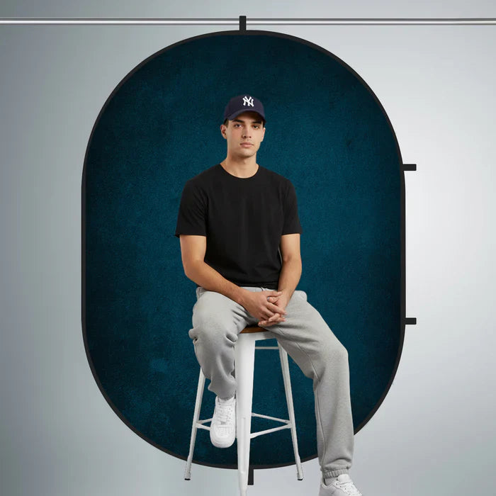 Young man sitting on chair and posing for his portrait photoshoot.