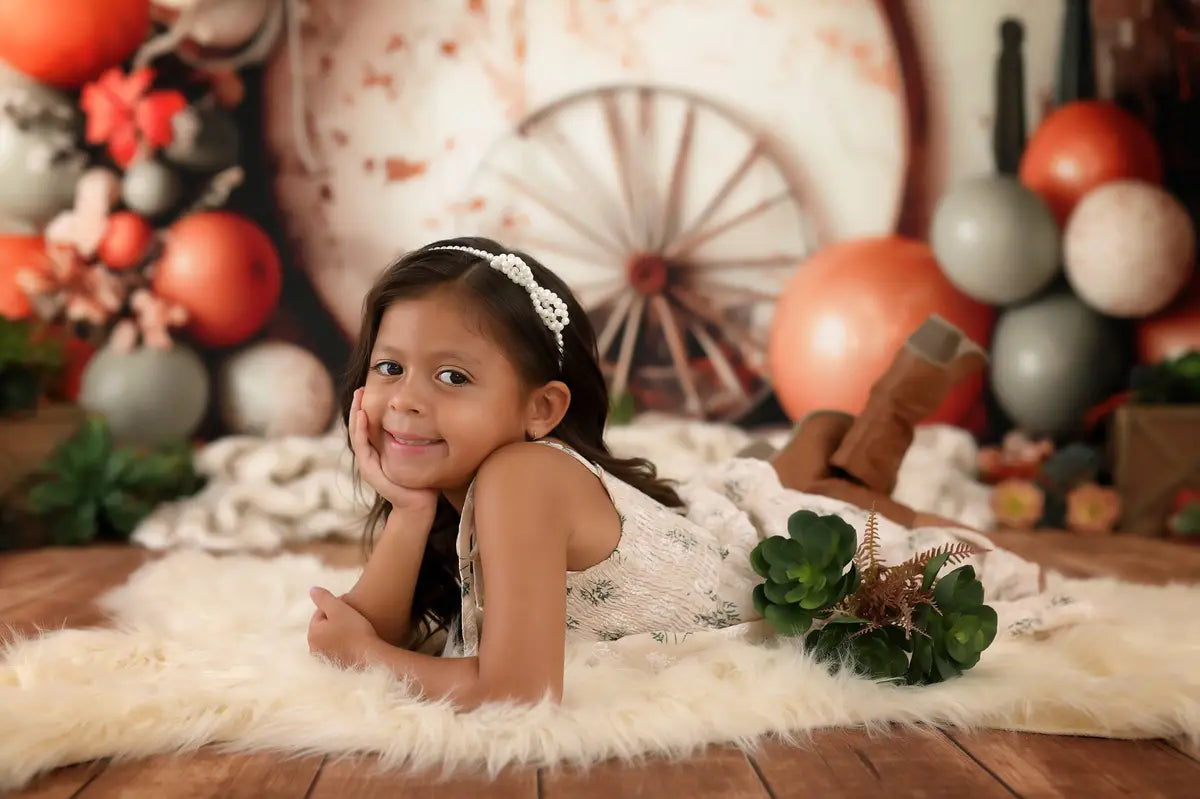 Kate Boho Wild West Colorful Balloon Brown Circle Wooden Wheel White Broken Wall Backdrop Designed by Patty Robert