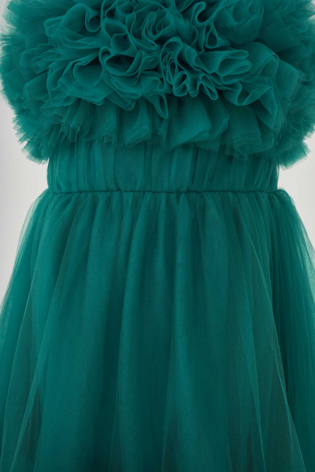 Detail shot of the waist of a green spring tulle maternity dress