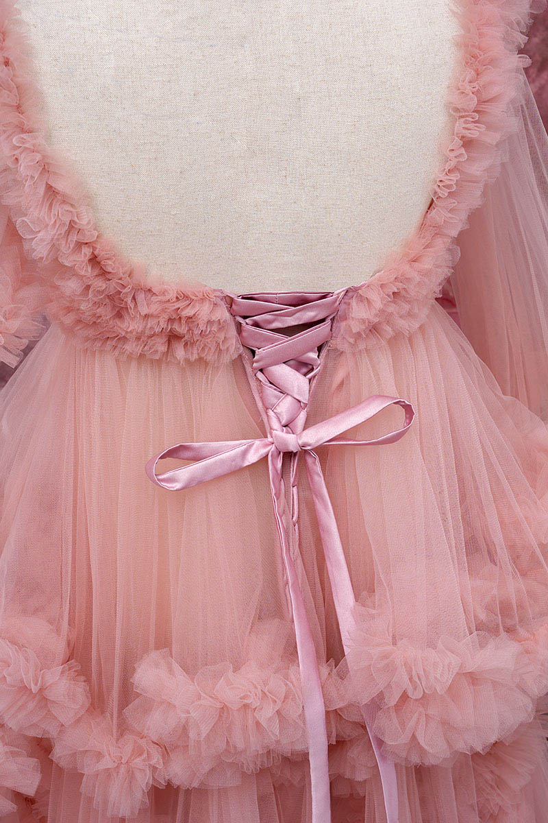 Detail shot of the back of a pink one-shoulder mesh maternity dress