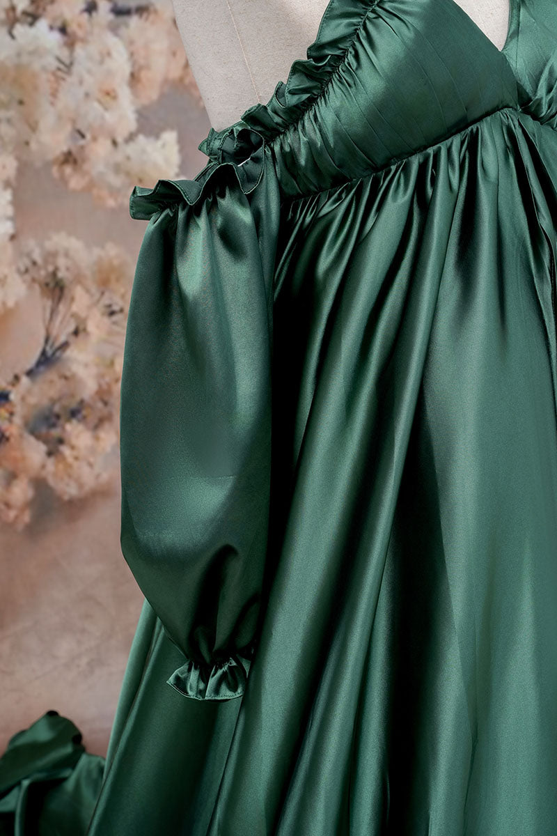 Side detail shot of green one-shoulder silk maternity maxi dress