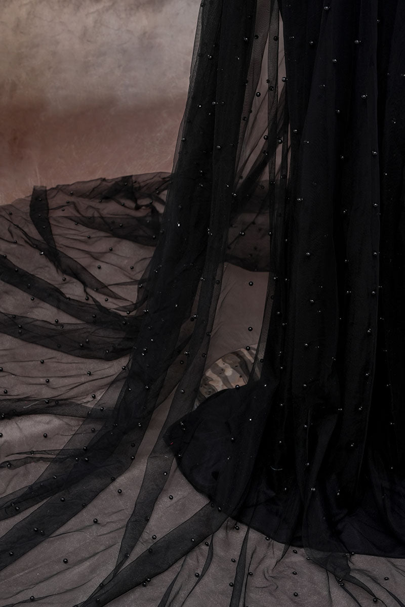 Detail shot of black one-shoulder mesh maternity dress