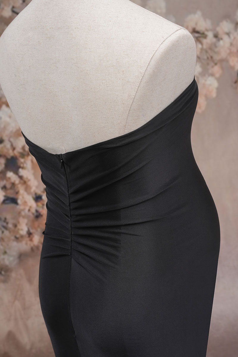 Side detail shot of black one-shoulder satin maternity dress