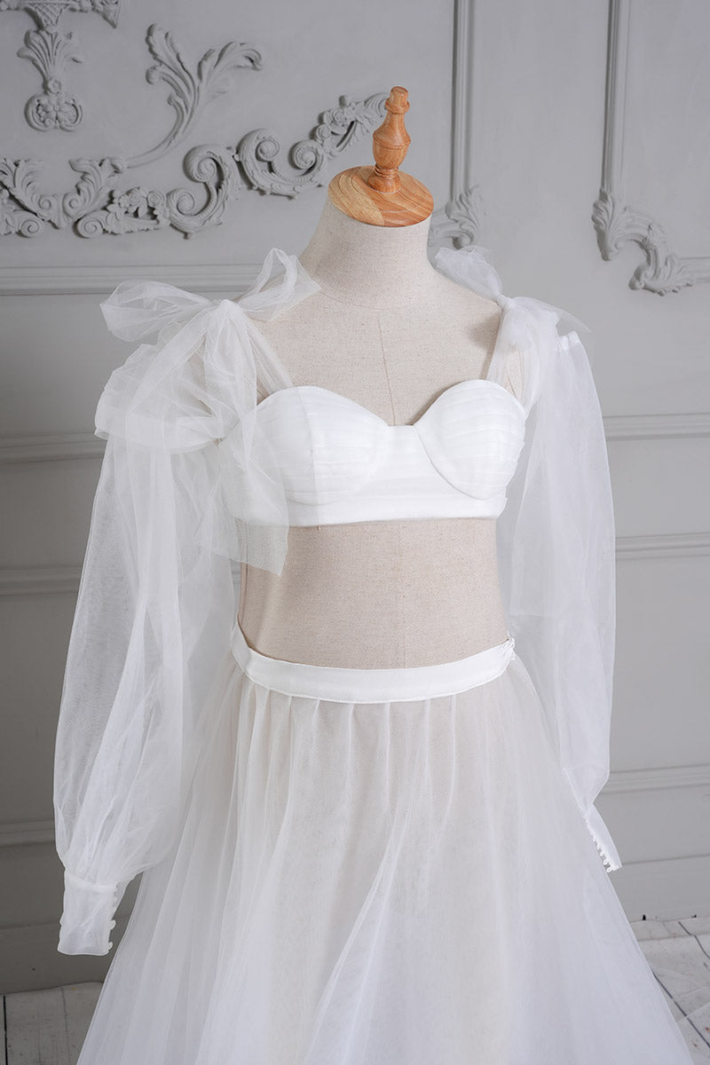 Detail shot of the front of a white sheath mesh maternity dress