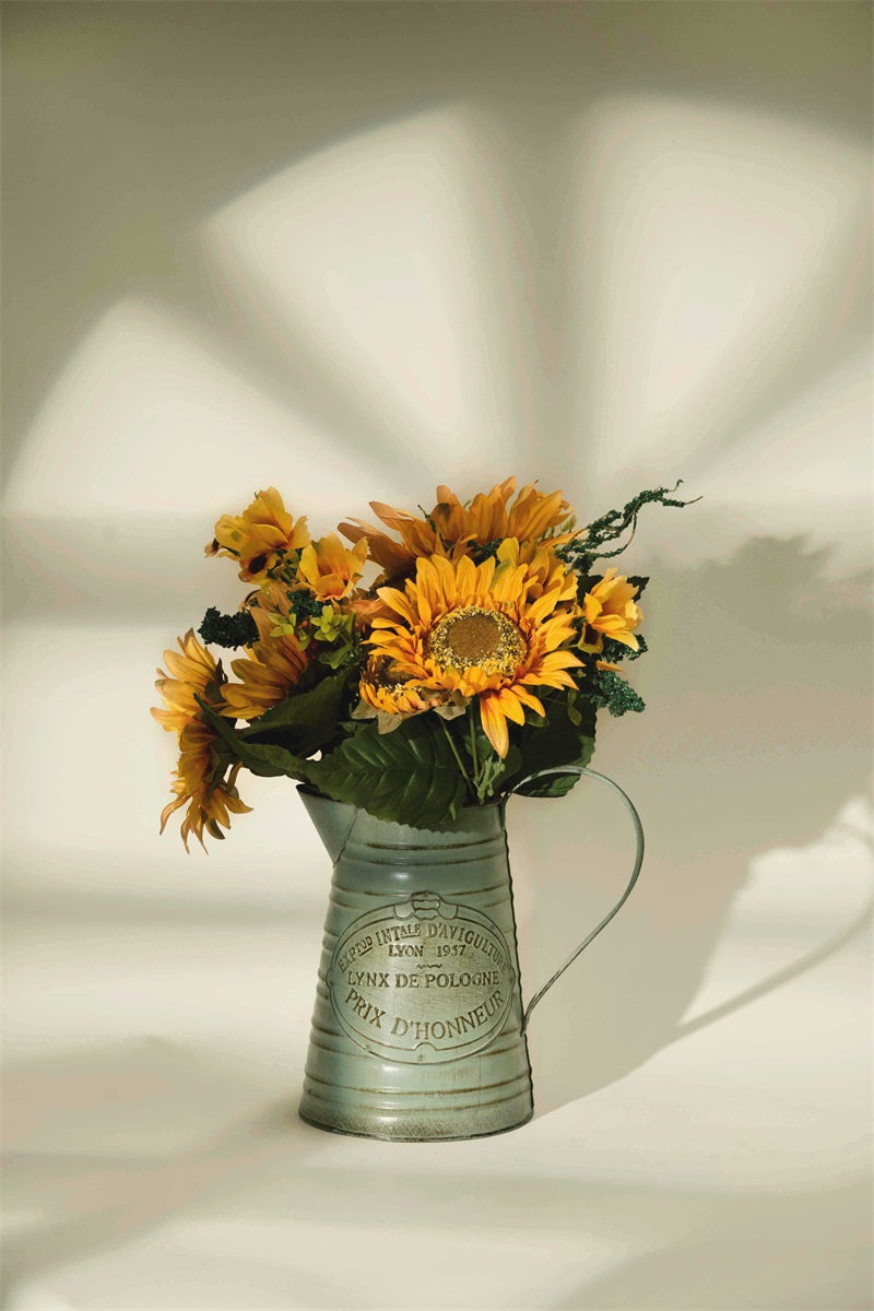 A vase filled with sunflowers in front of the beige seamless backdrop