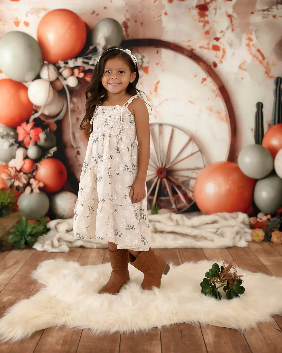 Kate Boho Wild West Colorful Balloon Brown Circle Wooden Wheel White Broken Wall Backdrop Designed by Patty Robert