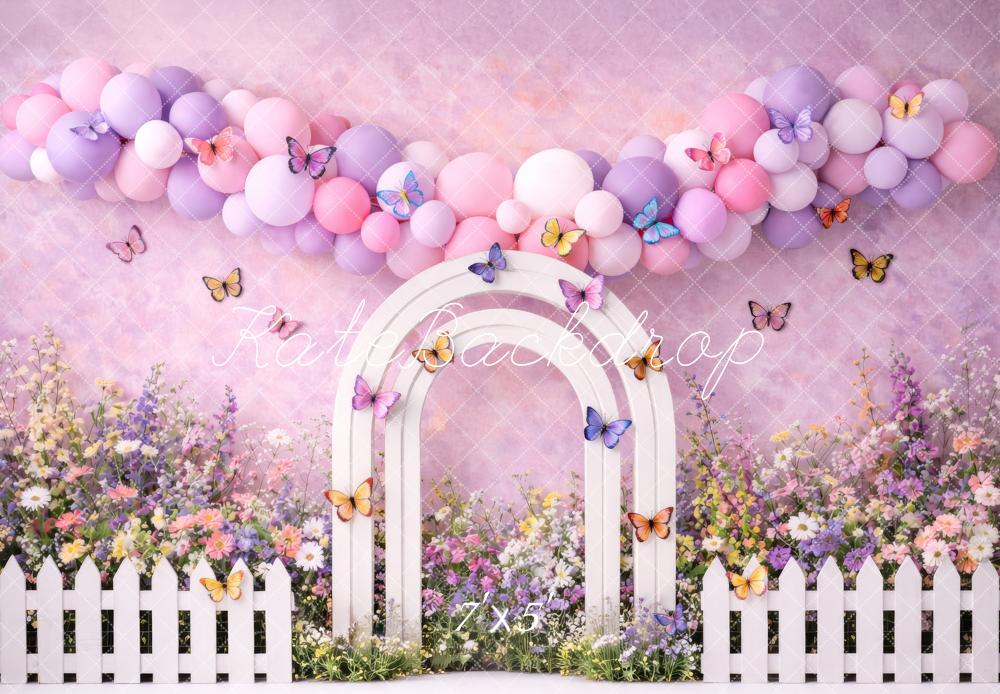 Kate Spring Flower Arch Pastel Balloons Butterflies White Fence Printed Backdrop Designed by Megan Leigh Photography