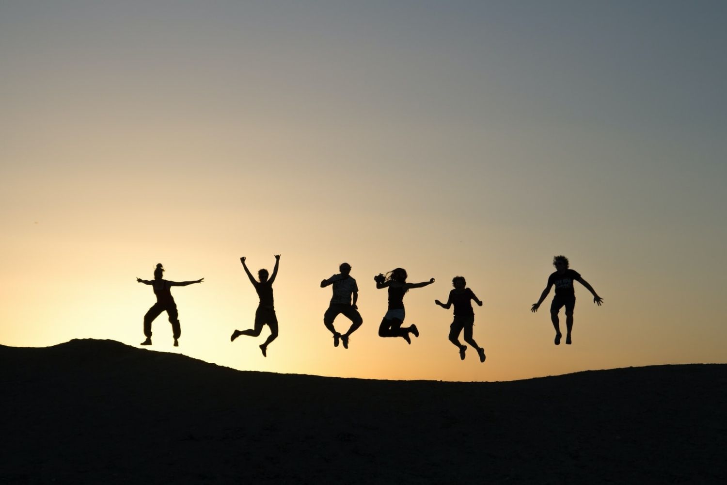 jumping group Photo by Timon Studler on Unsplash