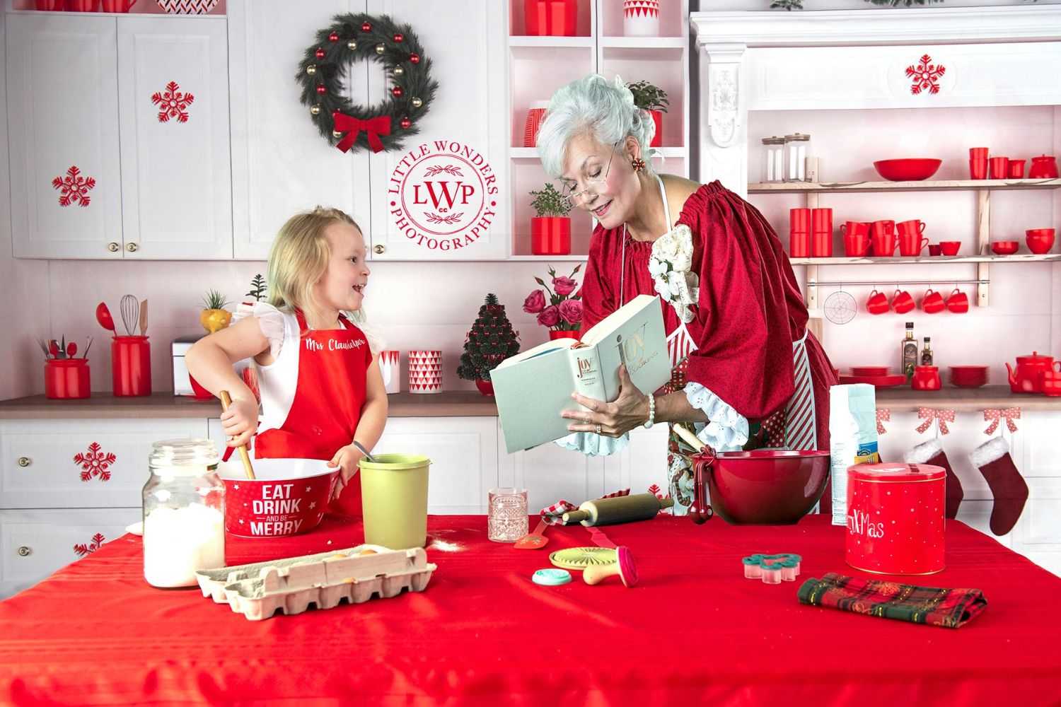 Christmas photo of grandma and grandchild with Kate White Christmas Kitchen Backdrop for Photography