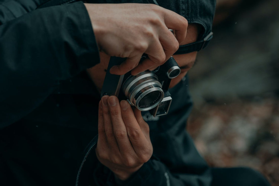 a man taking photo with a camera Photo by Clay Banks on Unsplash