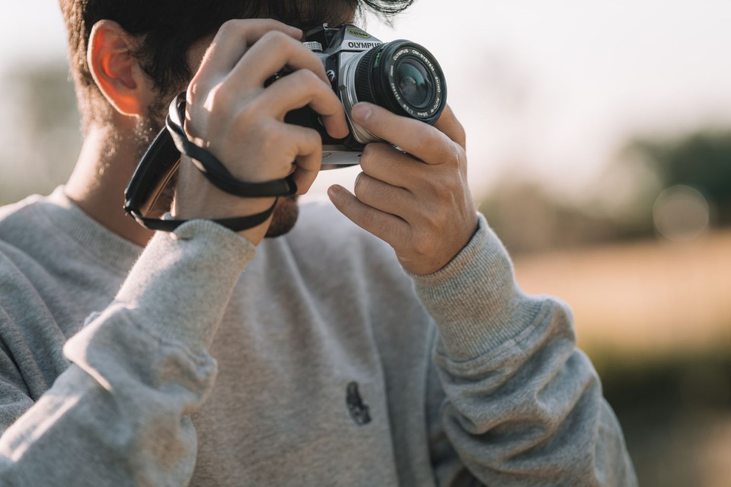 a man taking photo with a Olympus camera Photo by Federico Di Dio photography on Unsplash