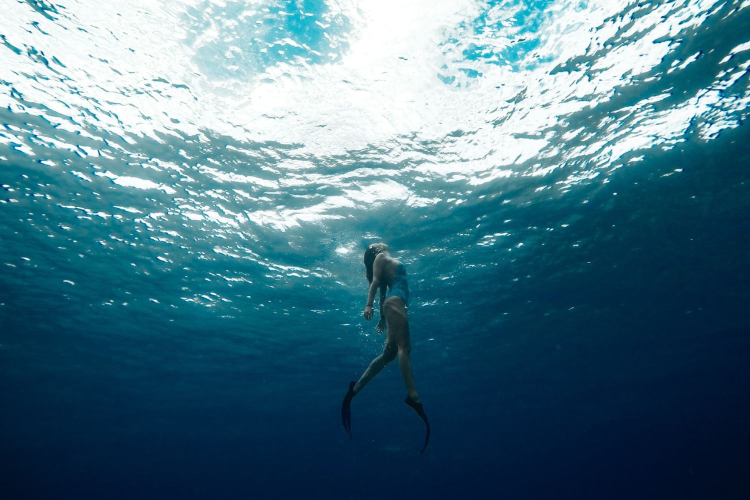 mermaid standing in the sea Photo by Jeremy Bishop on Unsplash