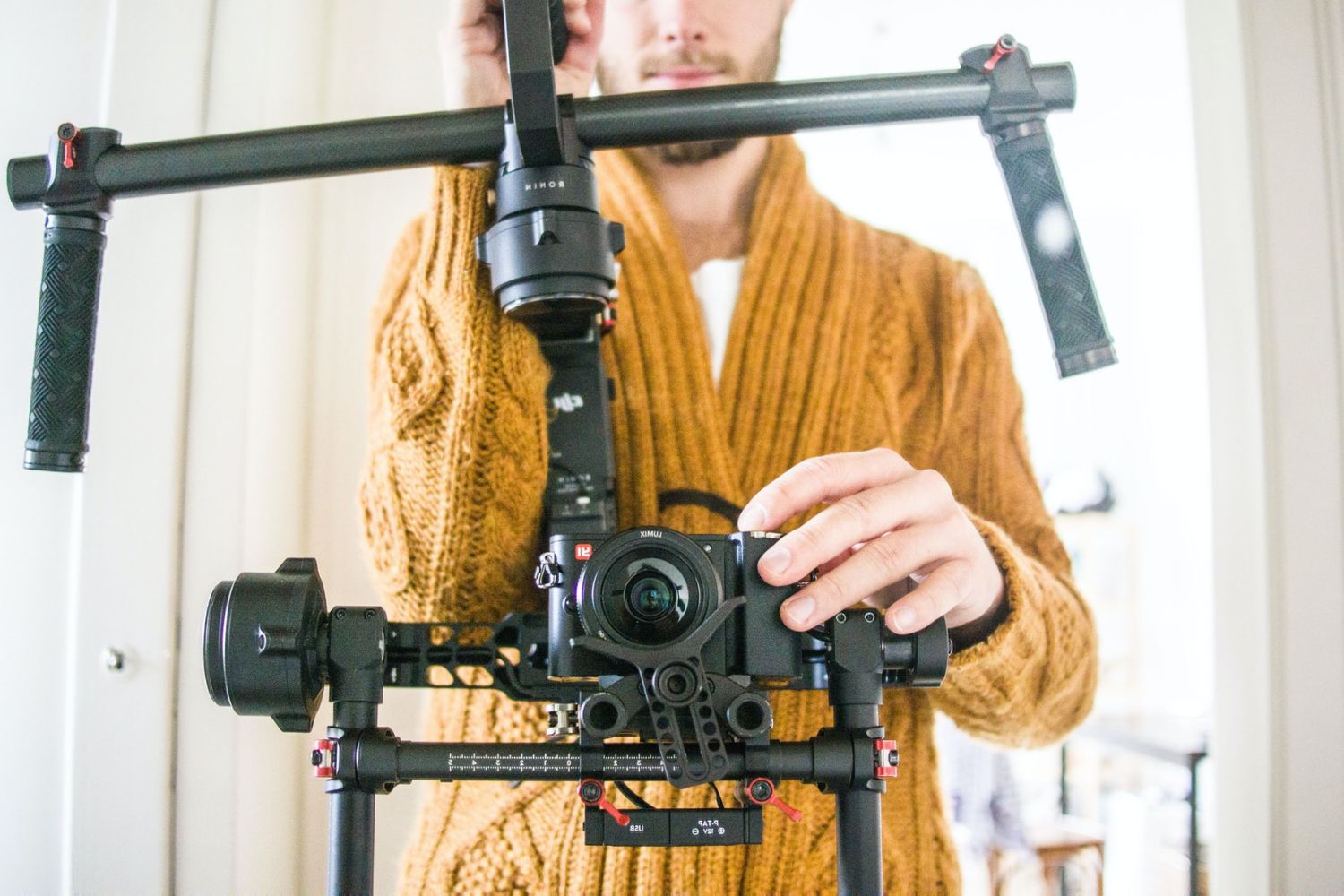 photo of a man holding a camera with stabilizer by Marvin Meyer on Unsplash