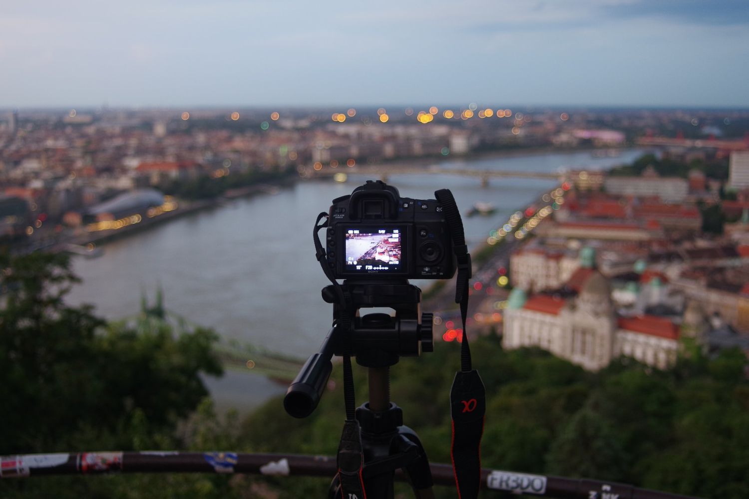 camera on tripod recording city Photo by Patrik Tuka on Unsplash