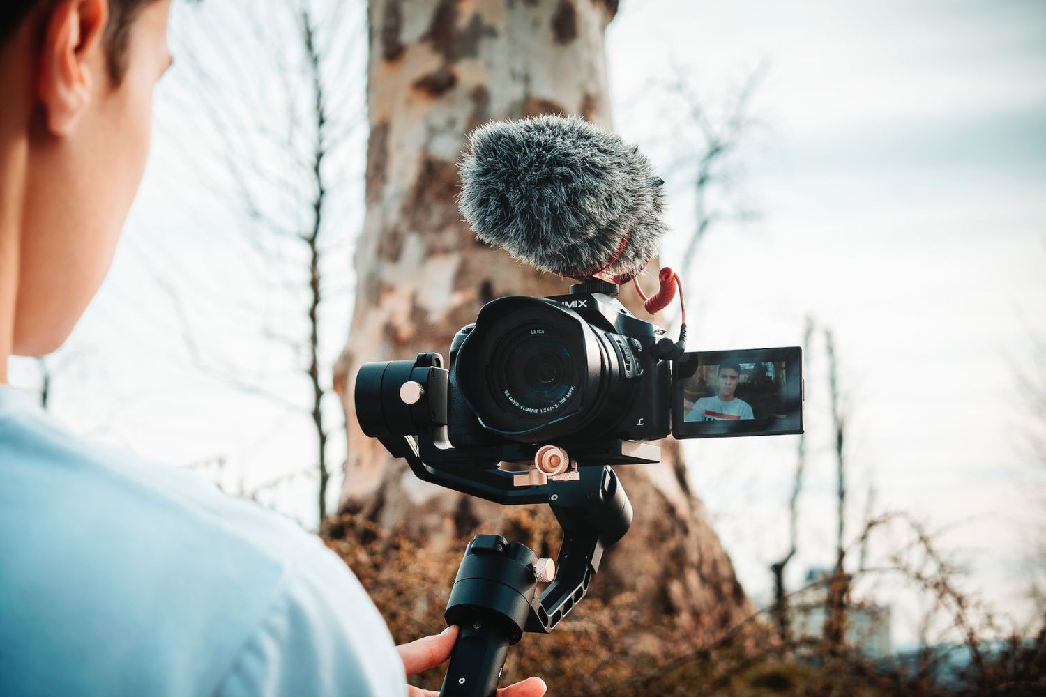 a man holding a gimbal and recording Photo by Sven Kucinic on Unsplash