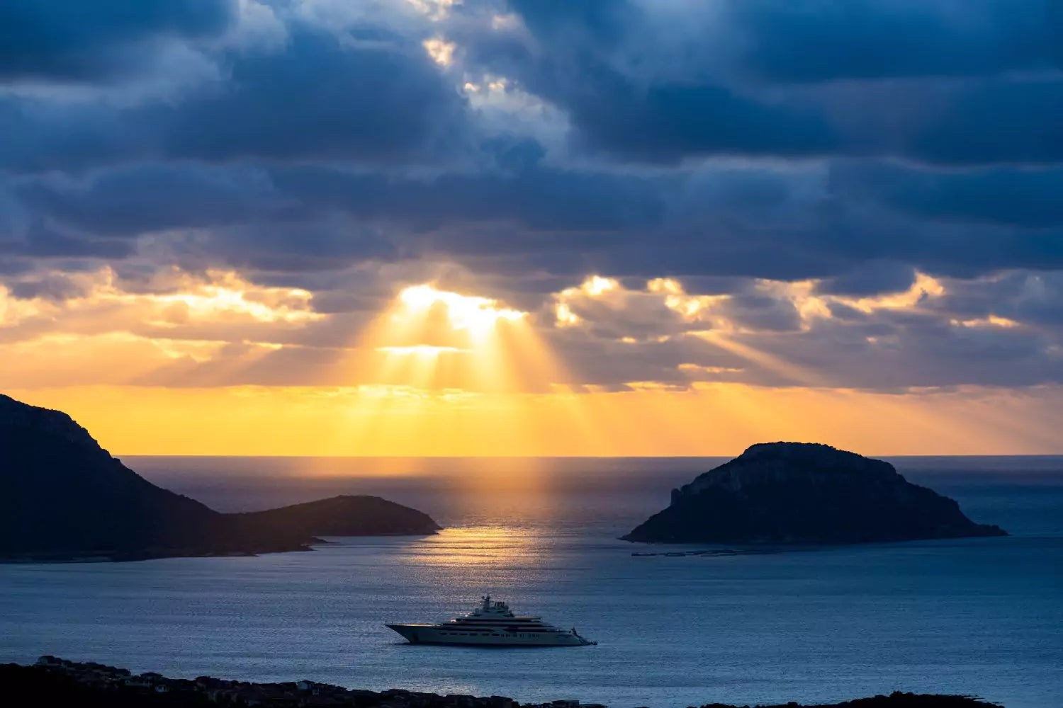 shaft of light above the ship in the sea. Photo by travelwild  on shutterstock