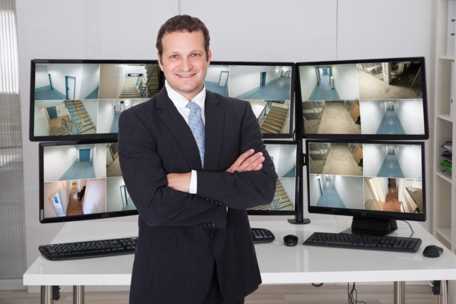 a man standing in front of the monitors photo by Andrey_Popov on shutterstock