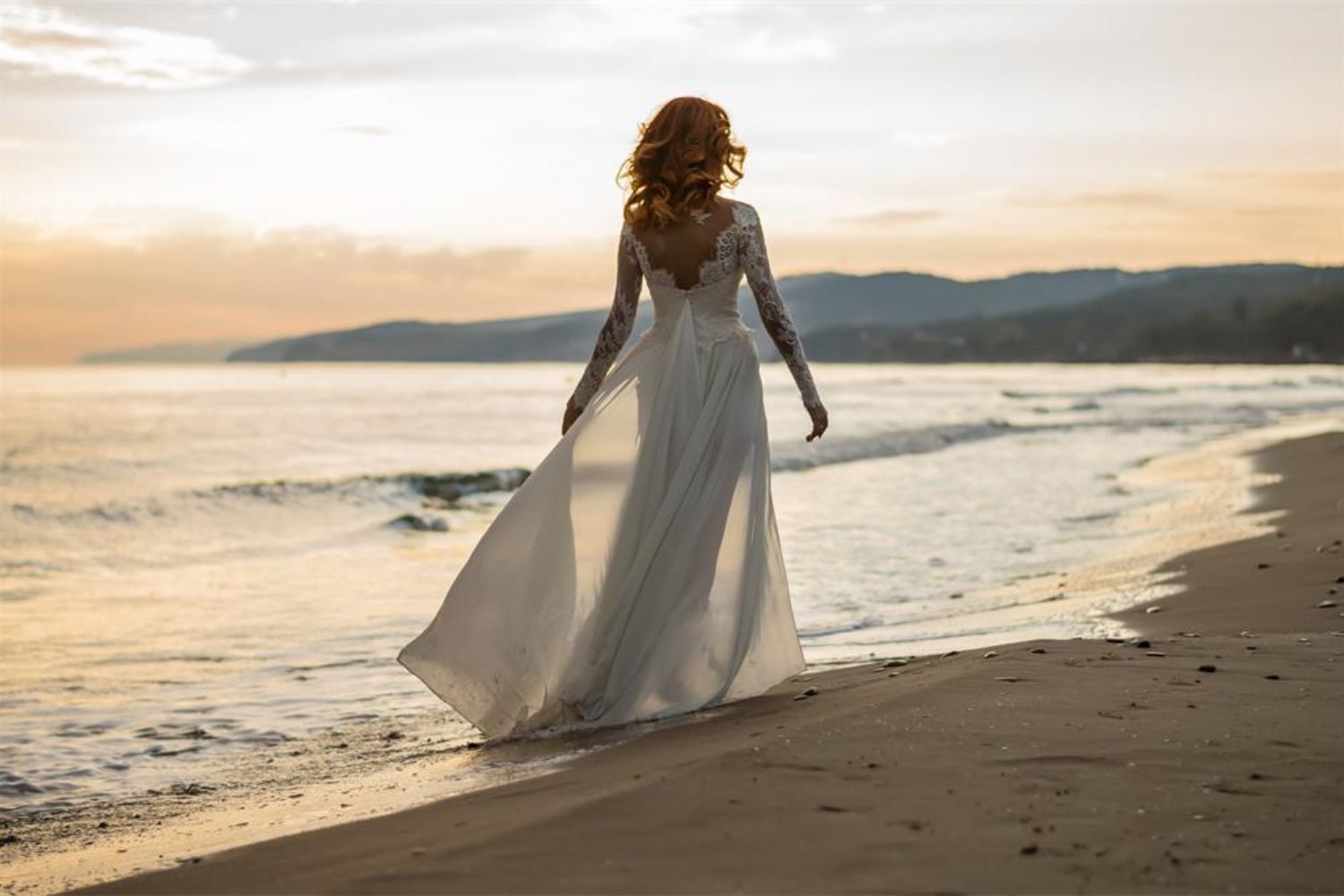 bride walking on beach photo by Martynova Marina on shutterstock