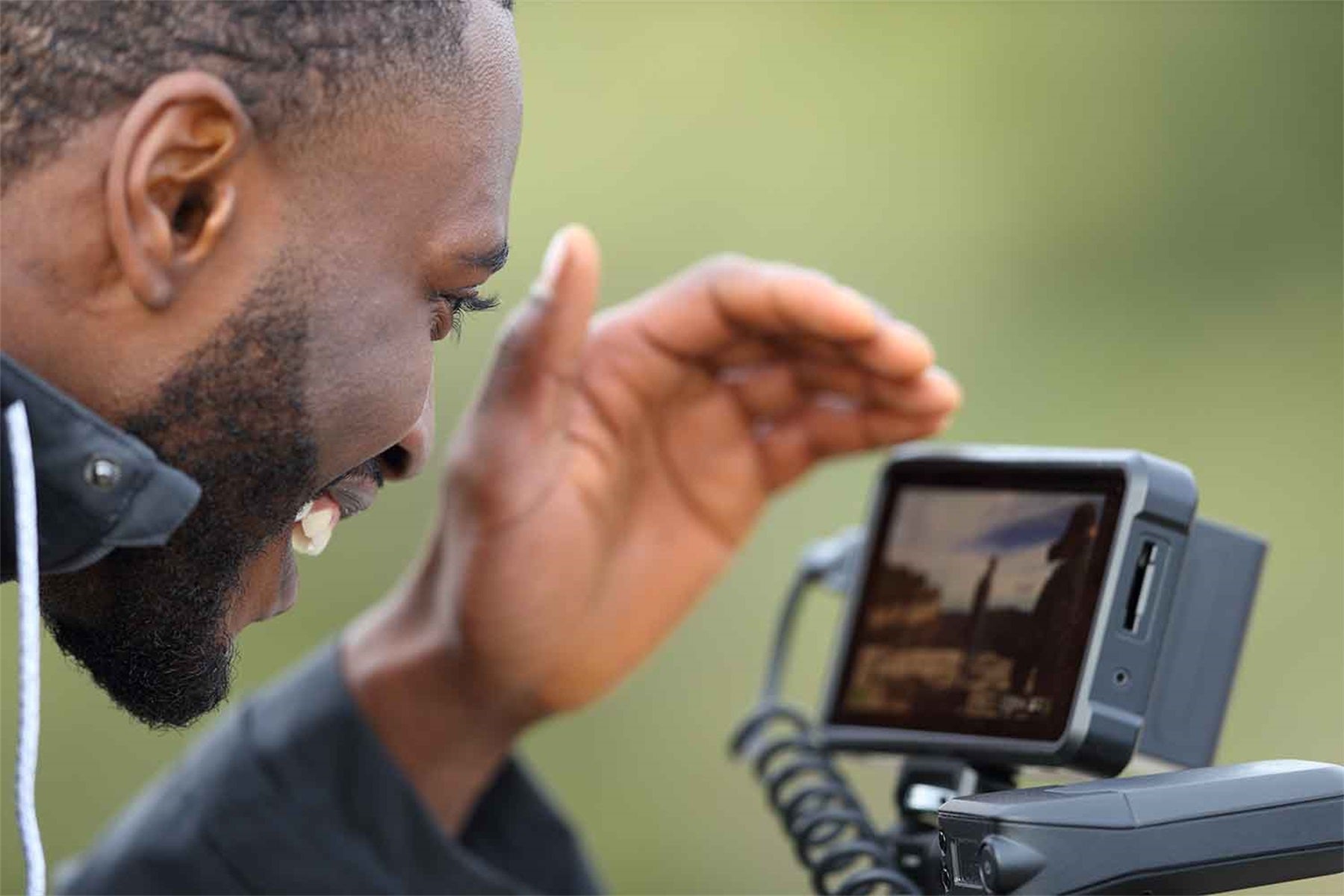 a man is looking at his external camera screen