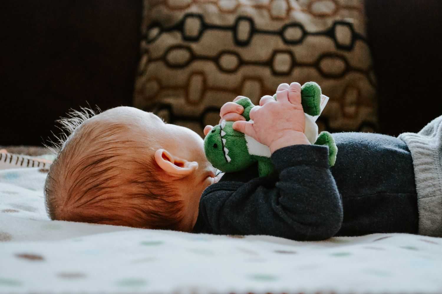 baby lies on the bed Photo by Kelly Sikkema on unsplash