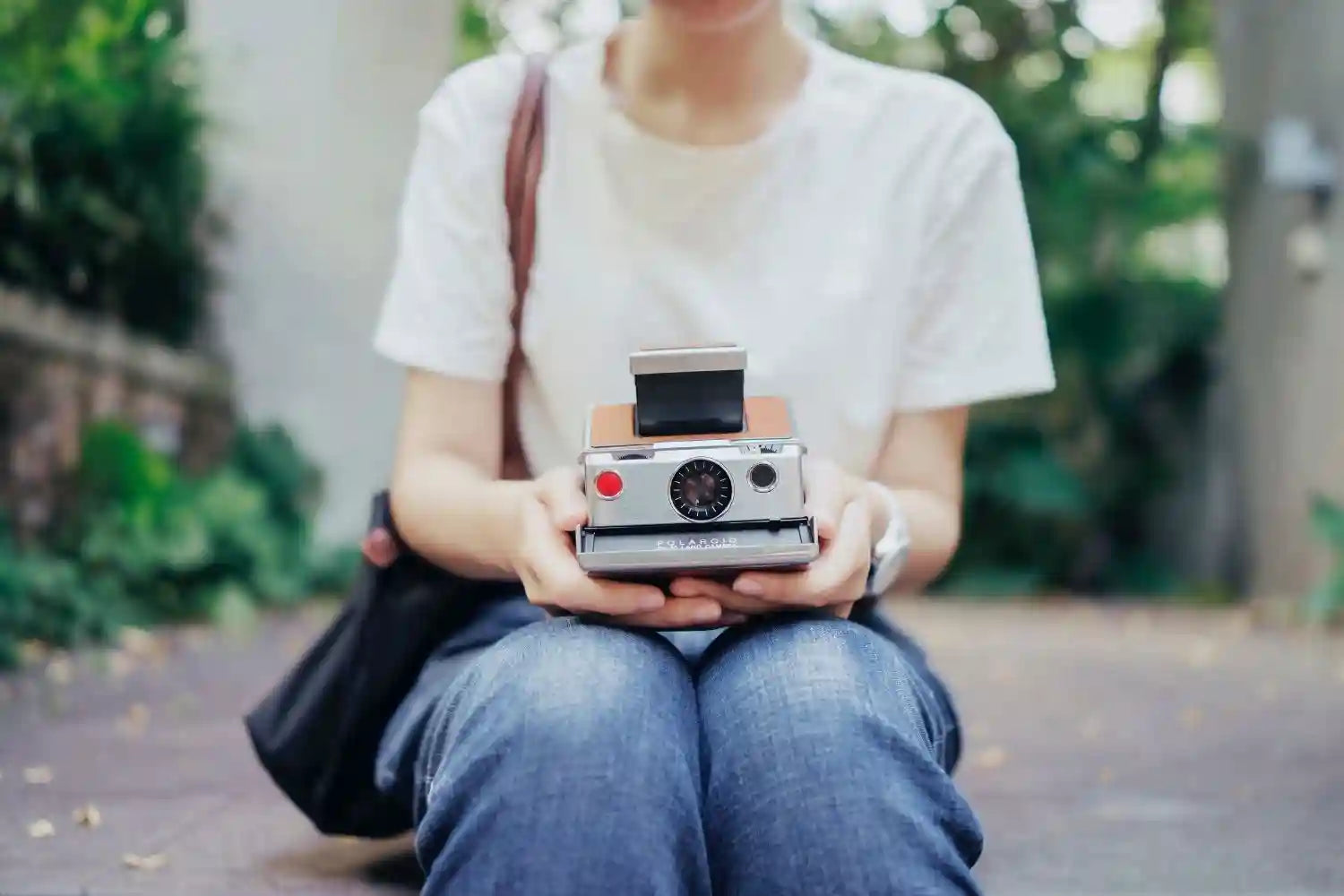 polaroid printer is putting on the woman's legs Photo by Marco Xu on unsplash