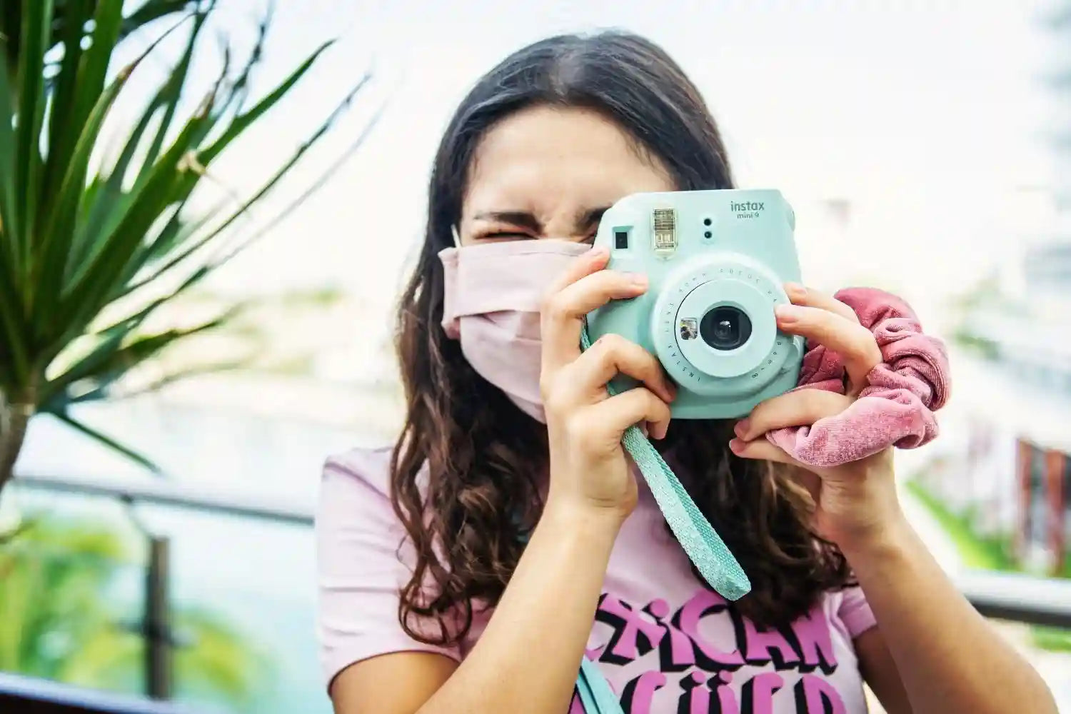 woman take photos with instax mini 9 Photo by Tim Mossholder on unsplash