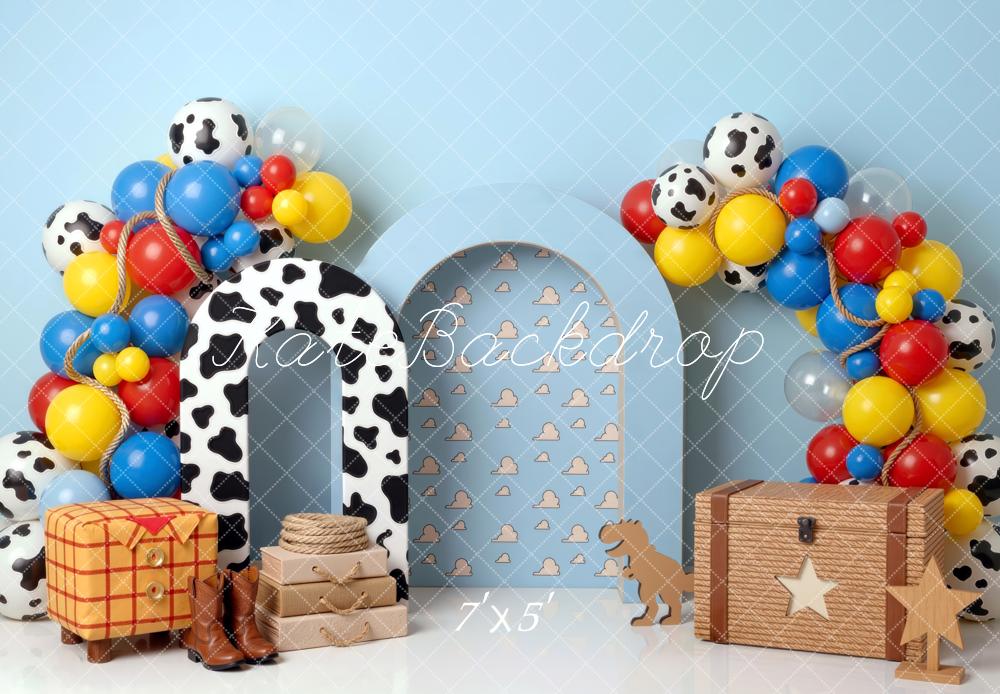 Kate Birthday Cowboy Cow Print Arch Balloons Toy Chest Blue Clouds Printed Backdrop Printed Backdrop Designed by Mini MakeBelieve