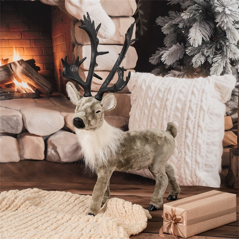 Decorative reindeer figure in front of a fireplace with Christmas decorations.