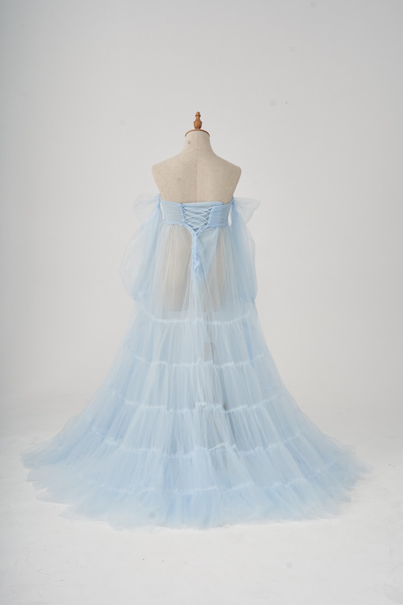 Blue sexy tulle maternity dress modelled on the back of the model