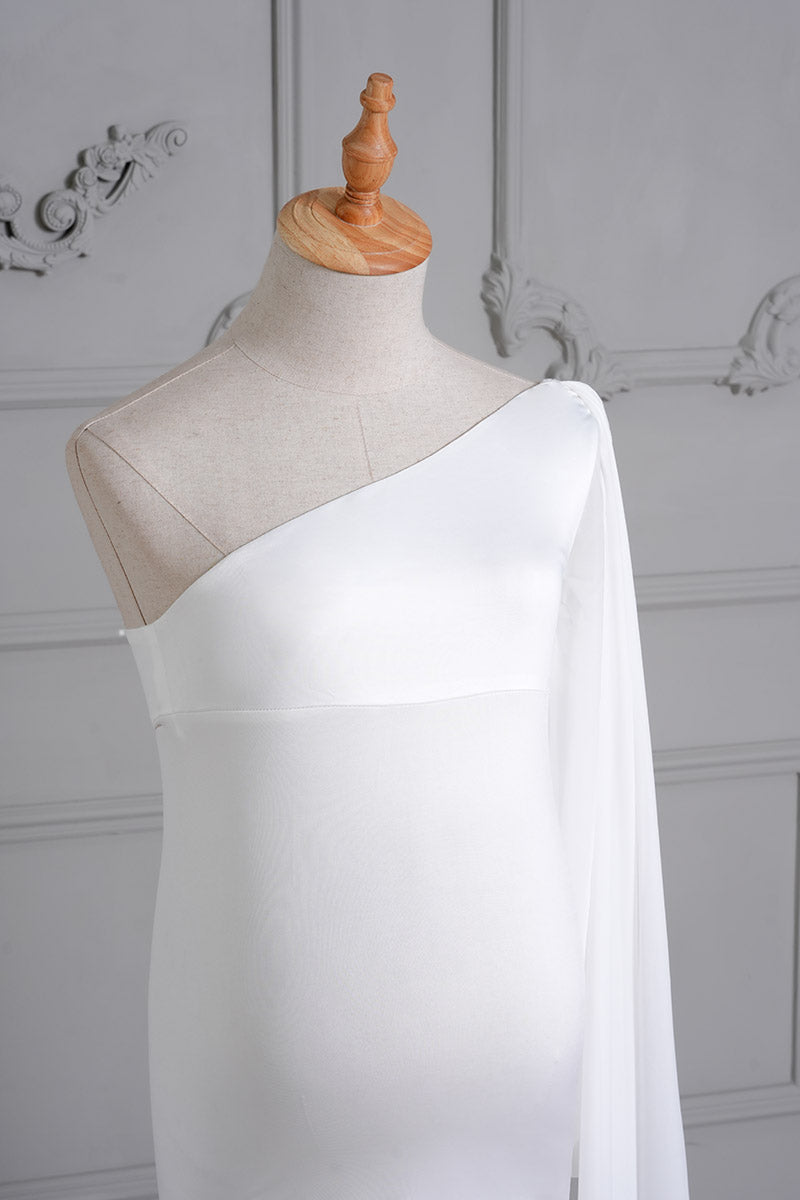 Detail shot of the front of a white one-shoulder satin maternity gown