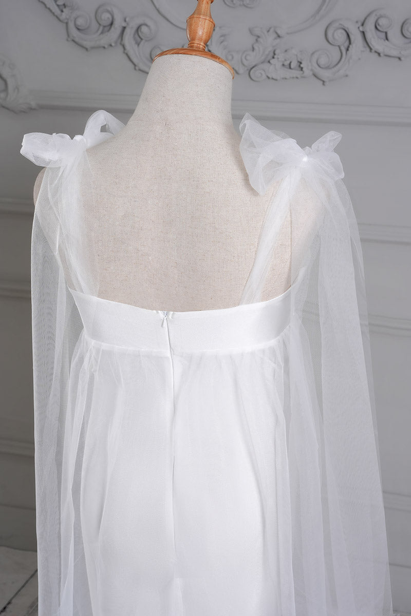 Detail shot of the back of a white one-shoulder mesh maternity dress