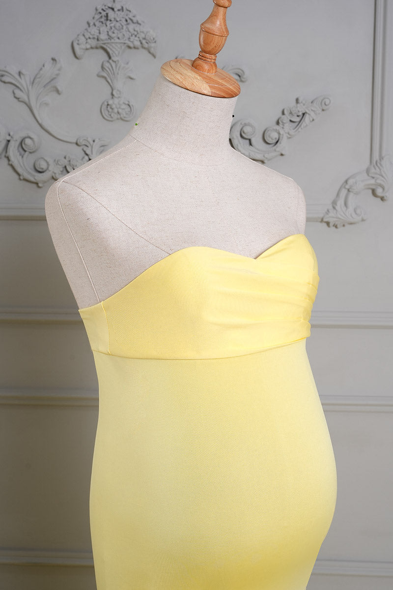 Detail shot of the side bust of a yellow one-shoulder satin maternity gown