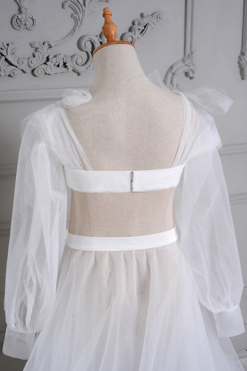  Detail shot of the back of a white sheath mesh maternity dress