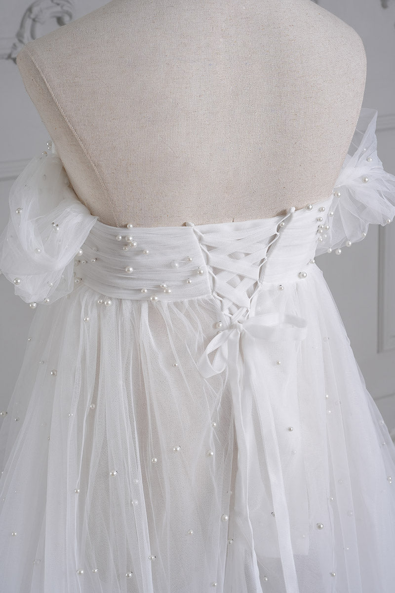 Detail shot of white sheath mesh maternity dress
