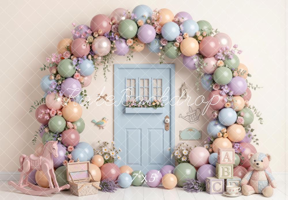 Kate Spring Birthday Pastel Balloon Flower Arch Blue Door Rocking Horse Teddy Bear Printed Backdrop Designed by Mini MakeBelieve