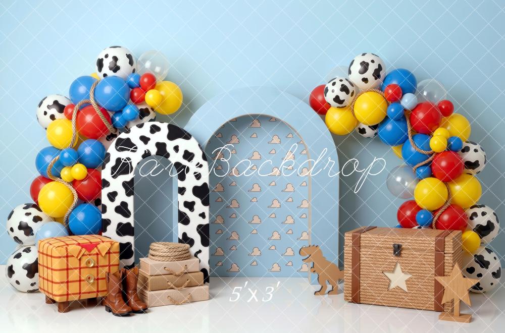 Kate Birthday Cowboy Cow Print Arch Balloons Toy Chest Blue Clouds Printed Backdrop Printed Backdrop Designed by Mini MakeBelieve
